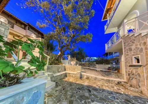 a villa with a staircase leading up to a building at Villa Eleni - Maisonette with Ocean panorama terrace in Alikanas