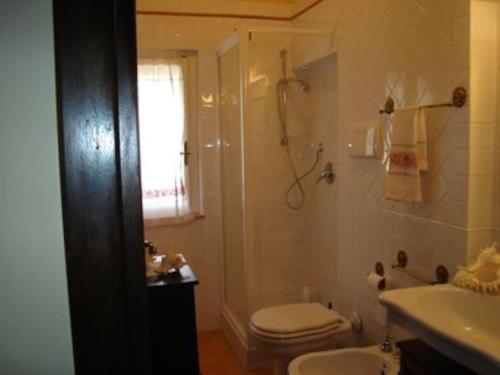 a bathroom with a toilet and a shower and a sink at Villa Stella in Pula
