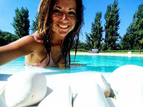 a woman in the water at a swimming pool at Tenuta Monaci La Murra in Carmiano