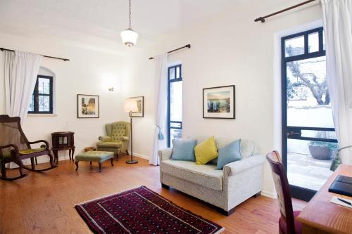 a living room with a couch and a table at The American Colony Hotel - Small Luxury Hotels of the World in Jerusalem