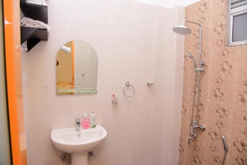 a small bathroom with a sink and a mirror at White Villa Airport Transit Hotel in Katunayake
