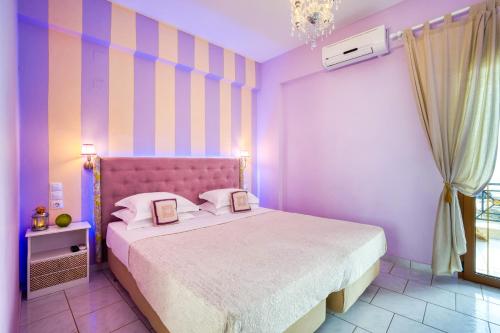 a bedroom with a bed with two pictures on it at Rozmari and Spa in Agia Galini