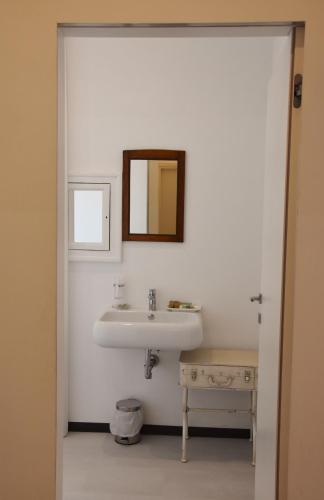 a bathroom with a sink and a mirror at La Casa nel Borgo Antico in Melfi
