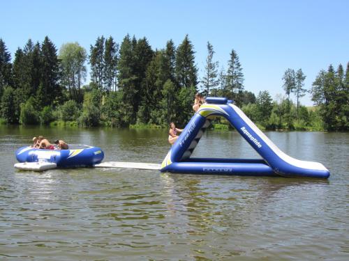 a group of people riding on an water slide in the water at Mobilheime in Klaffer am Hochficht