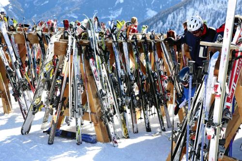 a bunch of skis are lined up on a rack in the snow at Heart Hotel Sylvia in Ischgl