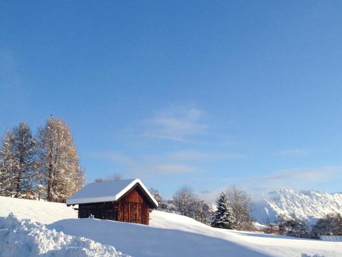 a barn covered in snow on a snow covered slope at Heart Hotel Sylvia in Ischgl