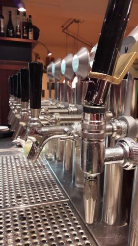 a row of wine glasses sitting on top of a machine at Gasthof Bogenrieder in Waidhofen