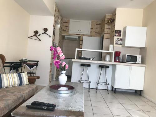 a living room with a couch and a kitchen at Appartements Brussel in Brussels