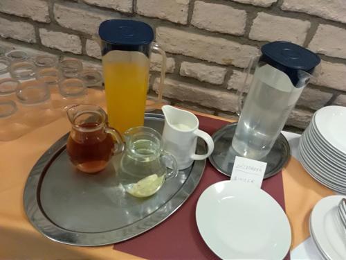a table with two glass pitchers and a plate with drinks at Villa A. Malka in Poděbrady