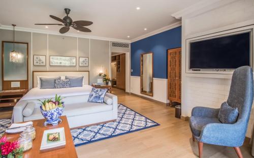 a bedroom with a large bed and a tv at Taj Exotica Resort & Spa, Goa in Benaulim