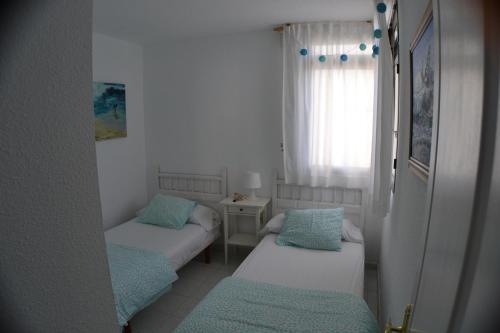 Ένα ή περισσότερα κρεβάτια σε δωμάτιο στο Sobre el Mar en Edificio Magallanes