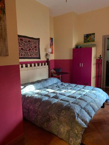a bedroom with a large bed and purple cabinets at Mondello Room in Mondello