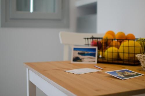 a kitchen counter with a basket of fruit on it at L’arco Milos Suite in Adamas