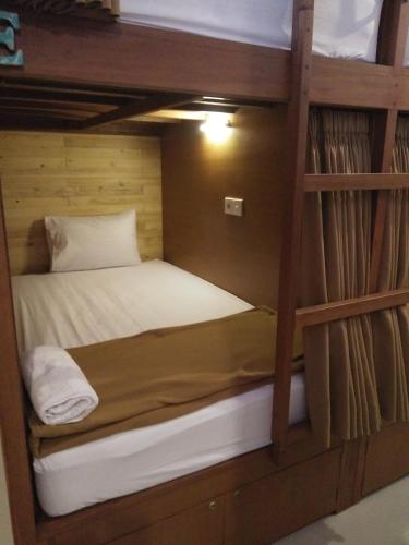 a bunk bed in a wooden bunk bed room at Made House Homestay and Dormitory in Sanur