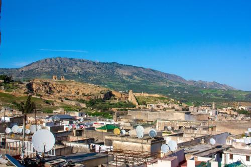 a view of a city with a mountain in the background at Dar El Bali in Fès