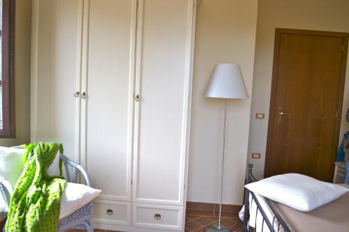 a bedroom with a bed and a white cabinet at Monte A Pescia in Pescia