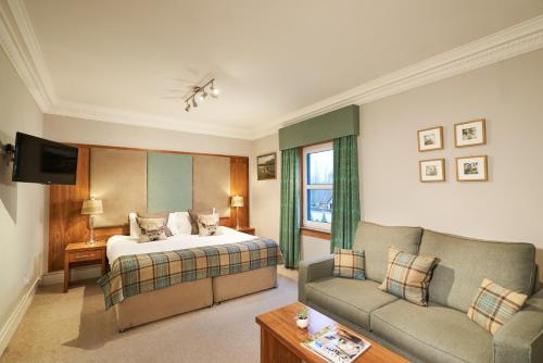 a hotel room with a bed and a couch at Poppies Hotel in Callander