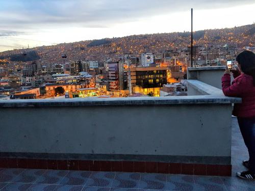 a woman taking a picture of a city at Residencial Uruguay in La Paz
