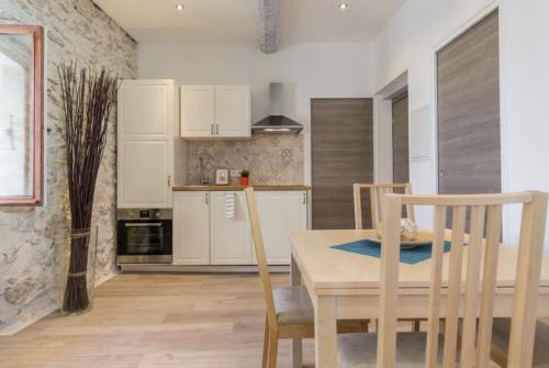 une cuisine avec une table et des chaises dans une pièce dans l'établissement VUE PICASSO - Agréable 2P vue musée Picasso et Mer, à Antibes