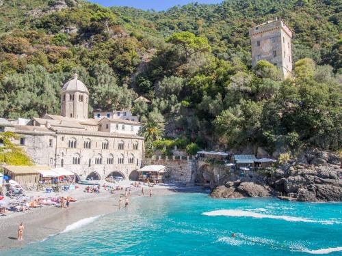 a group of people on a beach near the water at The italian riviera in San Salvatore