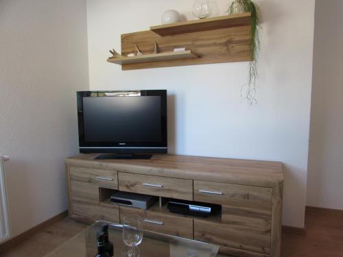 a flat screen tv sitting on top of a wooden dresser at Apart Schranz in Grins