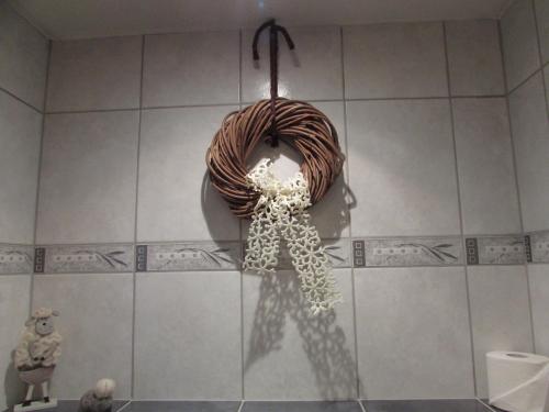 a bathroom with a wreath on the wall at Apart Schranz in Grins