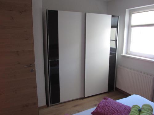 a bedroom with a door and a window at Apart Schranz in Grins