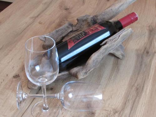 a bottle of wine and a glass on a table at Apart Schranz in Grins