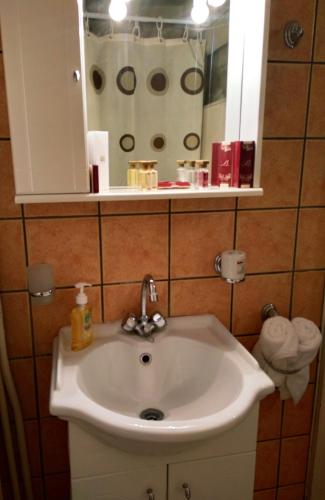 a white sink in a bathroom with a mirror at Xista Manor House ® in Pyrgi