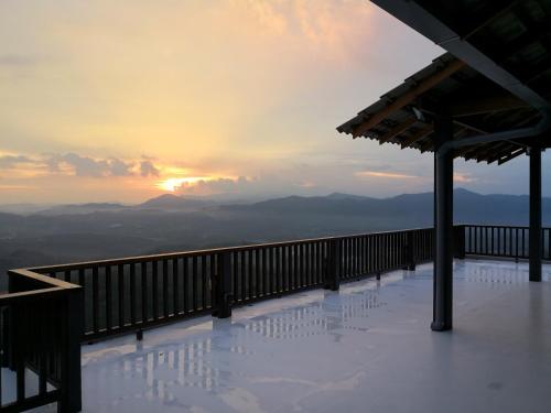 a view of the mountains from a balcony with the sunset at Kairos Villa in Seremban