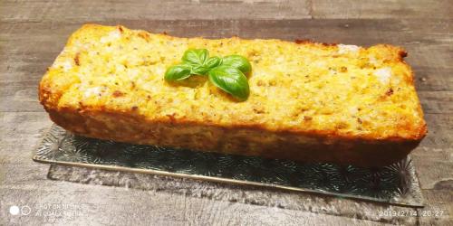 a cake on a plate with a green leaf on top at Le Temps d'une Pause in Bretignolles-sur-Mer