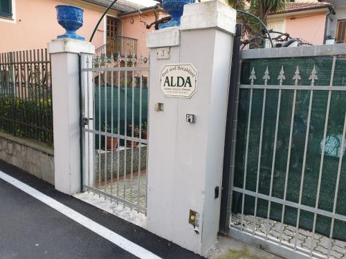 a gate with aania sign on it next to a fence at B&B ALDA in Levanto