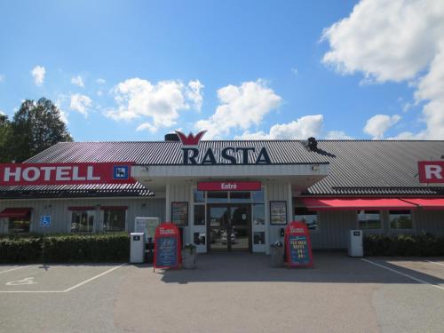 a hotel with two red signs in front of it at Rasta Arboga in Arboga