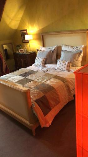 a bedroom with a large bed with pillows at La Maison de juliette in Saint-Hippolyte
