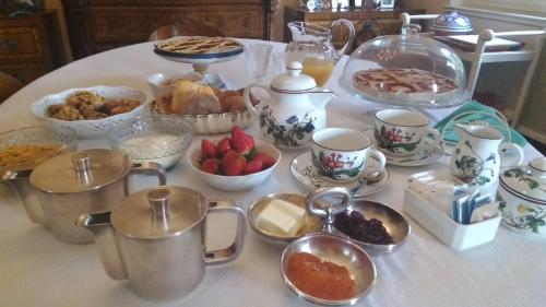 a table with a bunch of dishes of food on it at B&B La Villa Mediterranea in Passirano