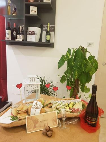 a table with a plate of food and a bottle of wine at Tenuta Vigna del Noce in Corato