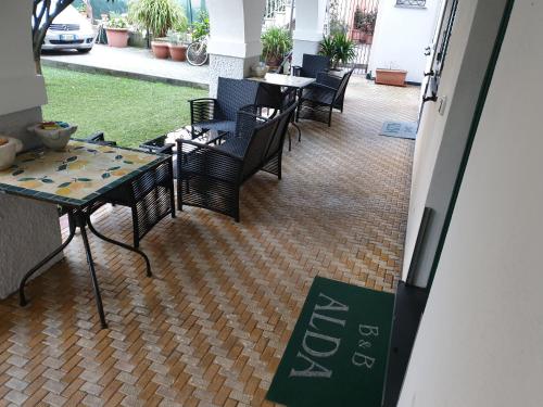 a restaurant with chairs and a table and a table and a table and chairs at B&B ALDA in Levanto