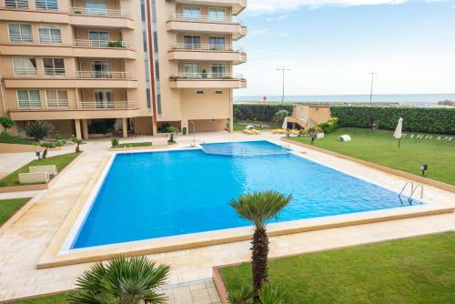 a large swimming pool in front of a building at BARRAMARES 3 in Furadouro