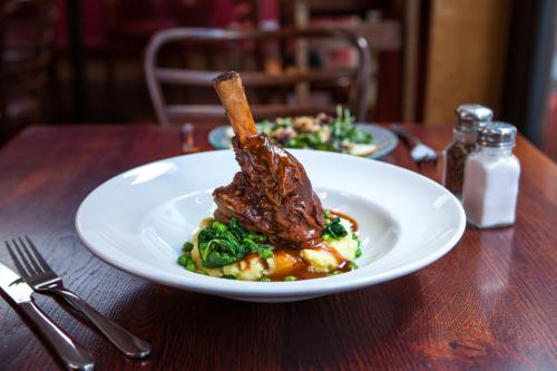 a plate of food on a wooden table at The Old Vine in Winchester