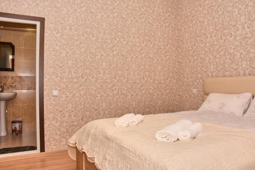 a bedroom with a bed with towels on it at Light House Old City in Akhaltsikhe