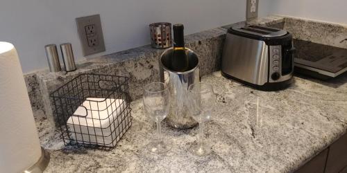 a counter with two glasses and a toaster and a toaster at Casa Tranquility in San Diego