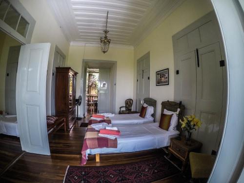 a bedroom with a large bed in a room at The Colonial Guest House in São Filipe