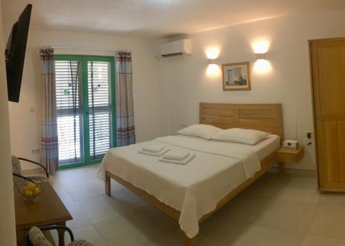 a bedroom with a bed with two towels on it at Apartment NECA in Lovište