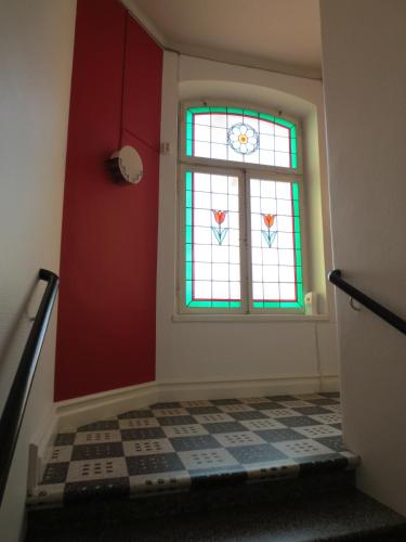 a room with a window and a checkered floor at Arboga Stadshotell in Arboga