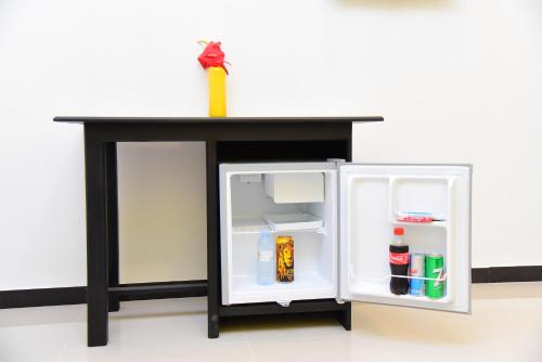 an open refrigerator with a counter on top of it at White Villa Airport Transit Hotel in Katunayake