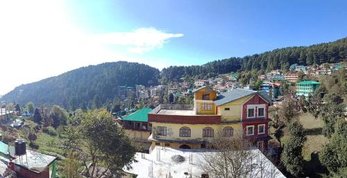 an aerial view of a town in the mountains at Mountain and Moon, Dharamkot in Dharamshala