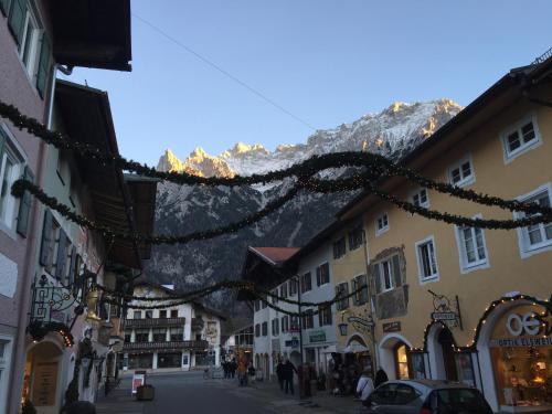 a street in a town with a mountain in the background at Karwendel Apartments II in Scharnitz