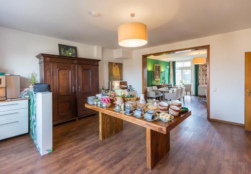 a living room with a table with food on it at Hotel Vorderburg in Schlitz