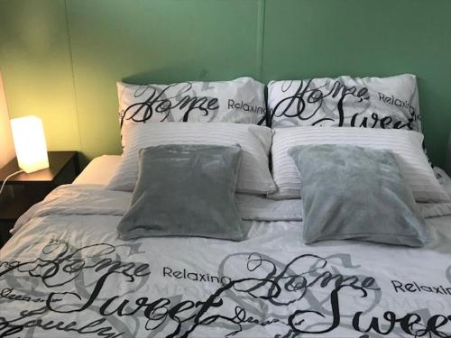 a bed with writing on it in a bedroom at Holiday Home 'Beautifull Water' in Lanaken