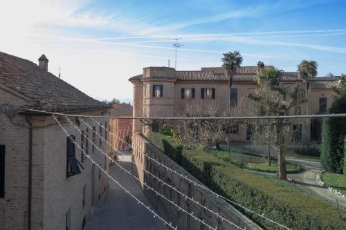 a view of a street with buildings and a fence at Terrazza sull'infinito in Recanati